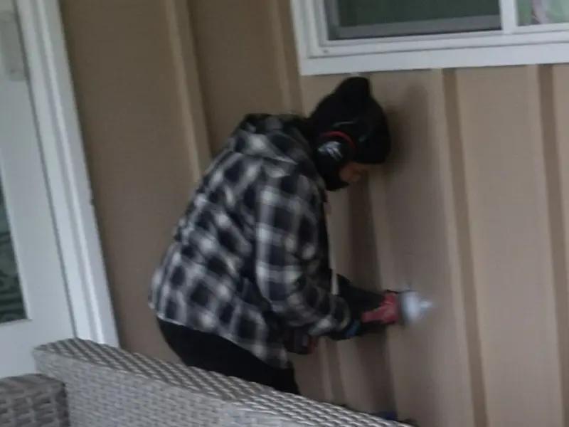 Professional electrician installing an exterior outlet in Columbia Falls